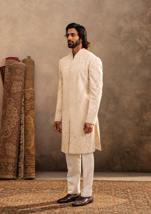 Ivory Regal Sherwani Set with Detailed Handwork and Shawl Draping Finish